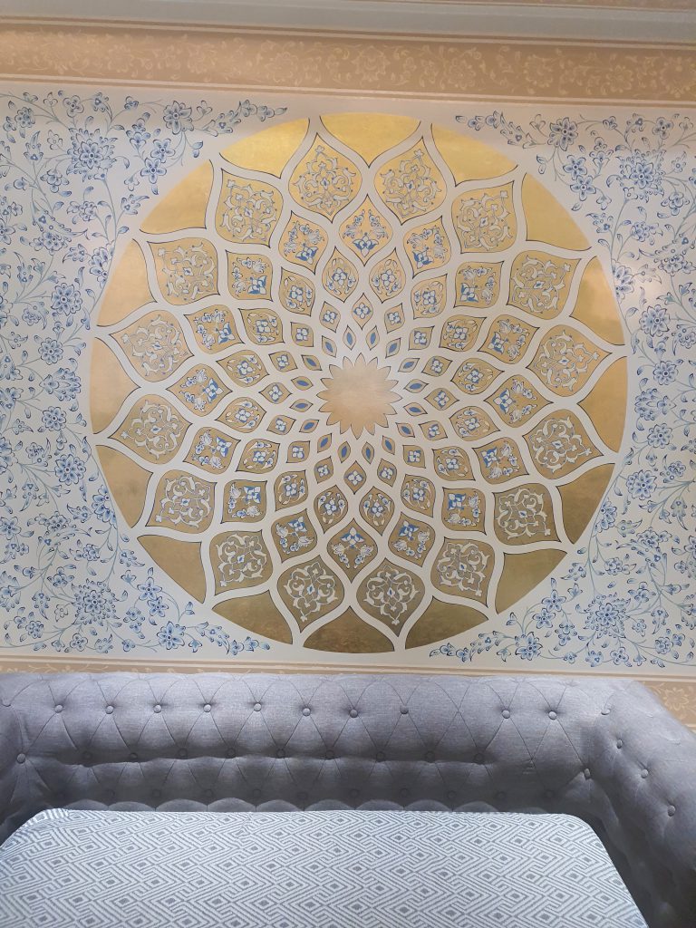 `Intricate hand-carved stucco details showcasing traditional Persian craftsmanship` 